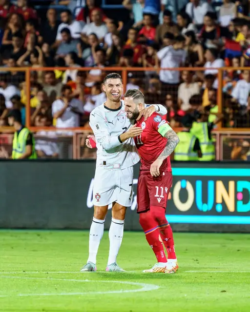 Players embracing after the final whistle, Armenia versus Portugal