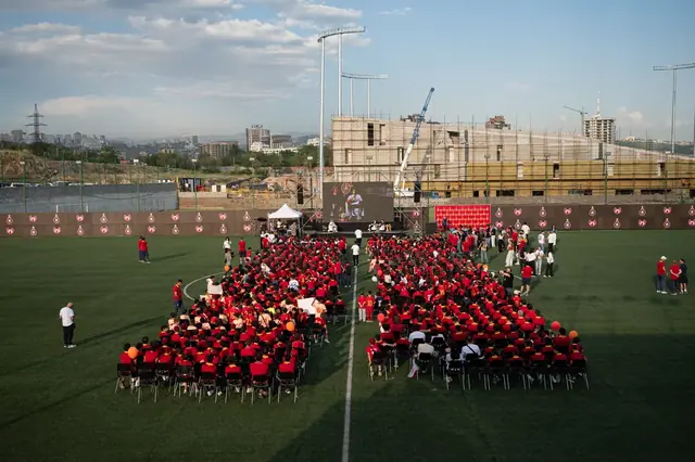 Aerial view of a mass gathering on a football pitch in Yerevan