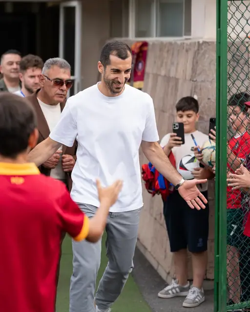 Henrikh Mkhitaryan greeting young fans on arrival